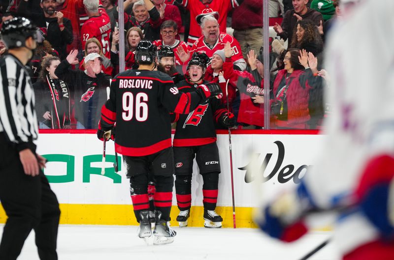 Nov 27, 2024; Raleigh, North Carolina, USA;  Carolina Hurricanes right wing Jackson Blake (53) is congratulated by defenseman Brent Burns (8) and center Jack Roslovic (96) after his goal against the New York Rangers during the third period at Lenovo Center. Mandatory Credit: James Guillory-Imagn Images