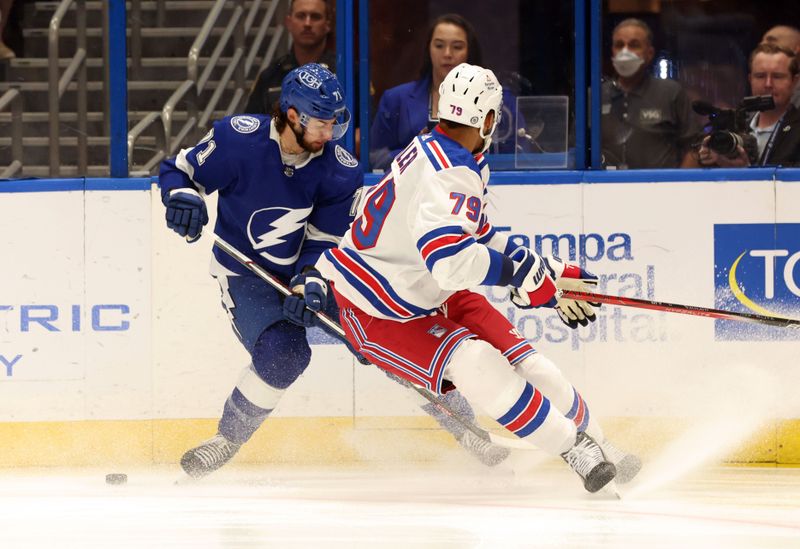 Mar 14, 2024; Tampa, Florida, USA; Tampa Bay Lightning center Anthony Cirelli (71) and New York Rangers defenseman K'Andre Miller (79) fight to control the puck during the first period at Amalie Arena. Mandatory Credit: Kim Klement Neitzel-USA TODAY Sports