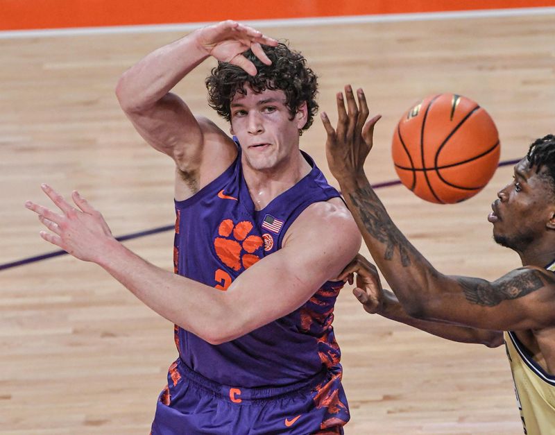 Jan 24, 2023; Clemson, South Carolina, USA; Clemson Tigers center PJ Hall (24) passes against Georgia Tech Yellow Jackets forward Jordan Meka (23) during the first half at Littlejohn Coliseum. Mandatory Credit: Ken Ruinard-USA TODAY Sports