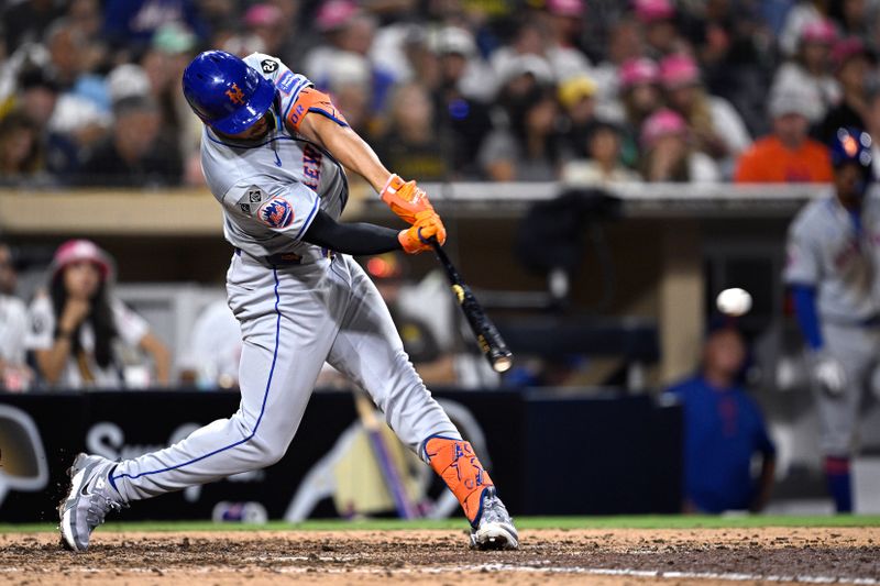 Aug 22, 2024; San Diego, California, USA; New York Mets center fielder Tyrone Taylor (15) hits a single against the San Diego Padres during the ninth inning at Petco Park. Mandatory Credit: Orlando Ramirez-USA TODAY Sports