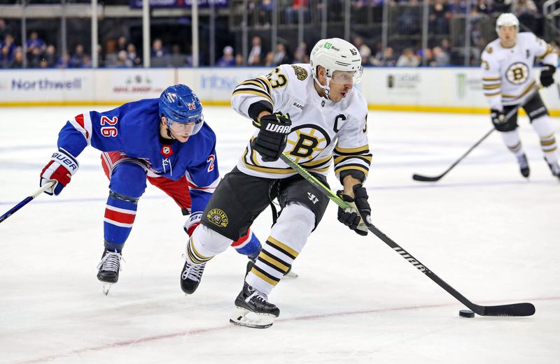 Nov 25, 2023; New York, New York, USA; Boston Bruins left wing Brad Marchand (63) skates with the puck in front off New York Rangers left wing Jimmy Vesey (26) during the third period at Madison Square Garden. Mandatory Credit: Danny Wild-USA TODAY Sports