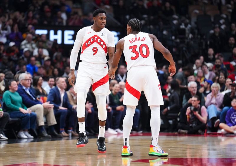 TORONTO, ON - NOVEMBER 18: RJ Barrett #9 and Ochai Agbaji #30 of the Toronto Raptors celebrate against the Indiana Pacers during the first half at the Scotiabank Arena on November 18, 2024 in Toronto, Ontario, Canada. NOTE TO USER: User expressly acknowledges and agrees that, by downloading and/or using this Photograph, user is consenting to the terms and conditions of the Getty Images License Agreement. (Photo by Mark Blinch/Getty Images)