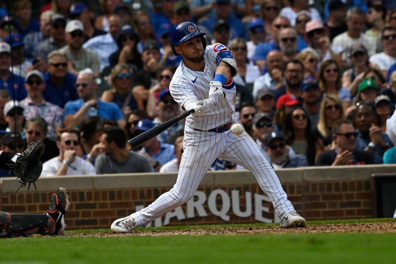 Sep 6, 2023; Chicago, Illinois, USA;  Chicago Cubs third baseman Nick Madrigal (1) hits an RBI single against the San Francisco Giants during the third inning at Wrigley Field. Mandatory Credit: Matt Marton-USA TODAY Sports