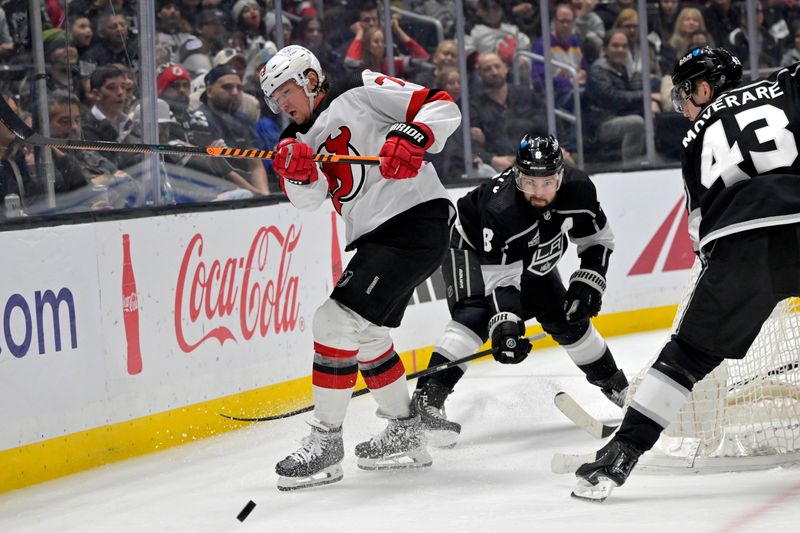 Mar 3, 2024; Los Angeles, California, USA;  New Jersey Devils right wing Tyler Toffoli (73) and Los Angeles Kings defenseman Drew Doughty (8) go for the puck in the third period at Crypto.com Arena. Mandatory Credit: Jayne Kamin-Oncea-USA TODAY Sports