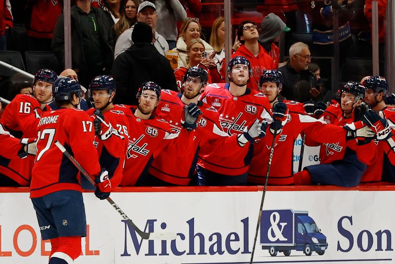 Jan 4, 2025; Washington, District of Columbia, USA; Washington Capitals center Dylan Strome (17) celebrates with teammates after scoring a goal against the New York Rangers in the first period at Capital One Arena. Mandatory Credit: Geoff Burke-Imagn Images