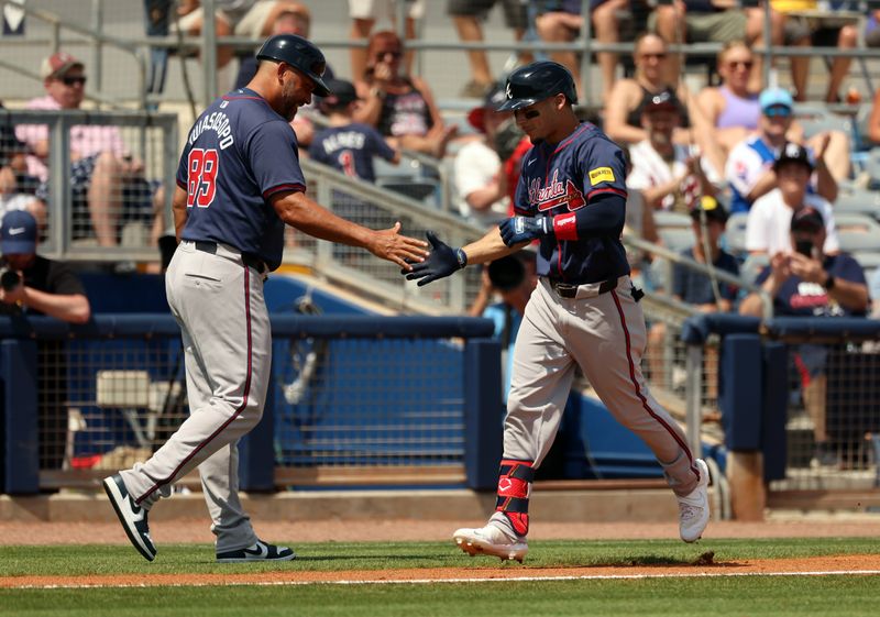 Mar 18, 2024; Port Charlotte, Florida, USA; Atlanta Braves infielder Andrew Velazquez (65)  is congratulated after he hit a home run during the fourth inning against the Tampa Bay Rays at Charlotte Sports Park. Mandatory Credit: Kim Klement Neitzel-USA TODAY Sports