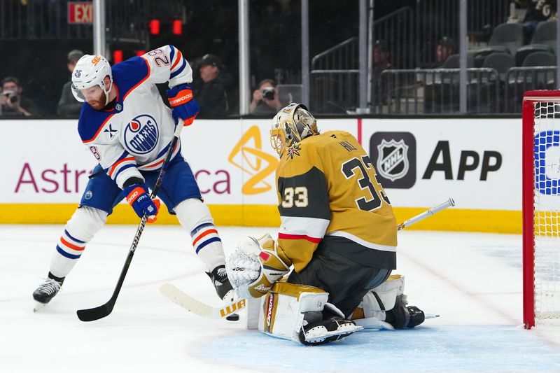 May 8, 2025; Las Vegas, Nevada, USA; Edmonton Oilers right wing Connor Brown (28) deflects the puck toward Vegas Golden Knights goaltender Adin Hill (33) during the first period of game two of the second round of the 2025 Stanley Cup Playoffs at T-Mobile Arena. Mandatory Credit: Stephen R. Sylvanie-Imagn Images