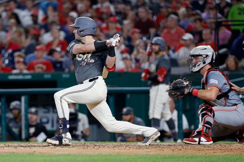 Jul 20, 2024; Washington, District of Columbia, USA; Washington Nationals outfielder Lane Thomas (28) hits an RBI double against the Cincinnati Reds during the seventh inning at Nationals Park. Mandatory Credit: Geoff Burke-USA TODAY Sports