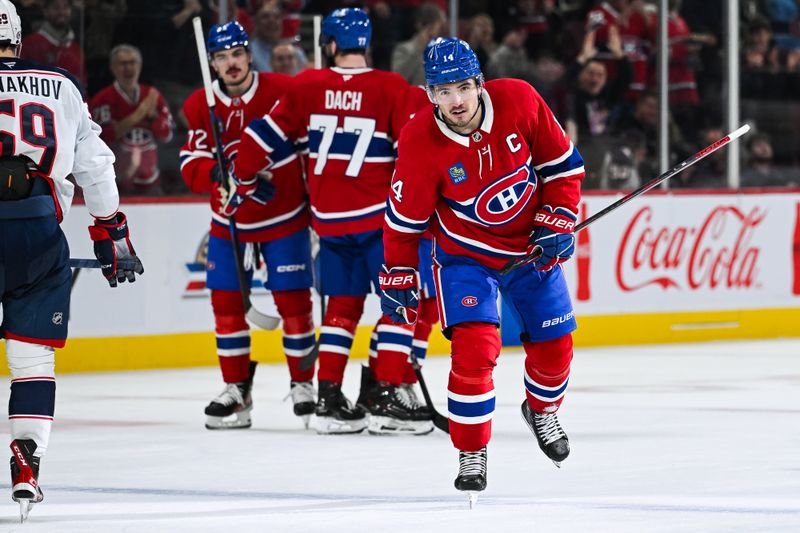 Nov 16, 2024; Montreal, Quebec, CAN; Montreal Canadiens center Nick Suzuki (14) skates back to the bench after celebrating his goal -ac= with his teammates during the second period at Bell Centre. Mandatory Credit: David Kirouac-Imagn Images