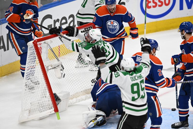 Jun 2, 2024; Edmonton, Alberta, CANthe Dallas Stars left winger Mason Marchment (27) crashes into the net and Edmonton Oilers goalie Stuart Skinner (74) during the third period in game six of the Western Conference Final of the 2024 Stanley Cup Playoffs at Rogers Place. Mandatory Credit: Walter Tychnowicz-USA TODAY Sports