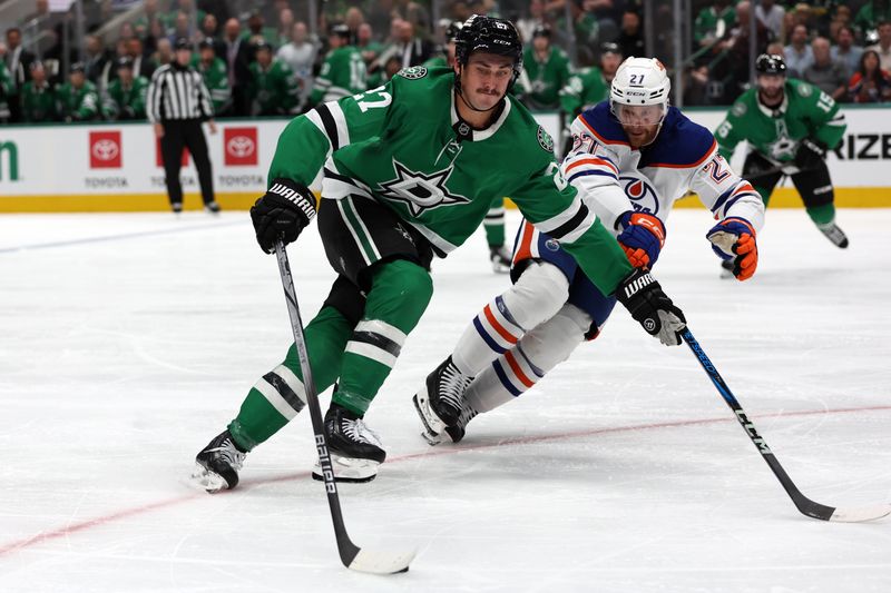 Oct 19, 2024; Dallas, Texas, USA; Dallas Stars left wing Mason Marchment (27) controls the puck against Edmonton Oilers defenseman Brett Kulak (27) in the second period at American Airlines Center. Mandatory Credit: Tim Heitman-Imagn Images