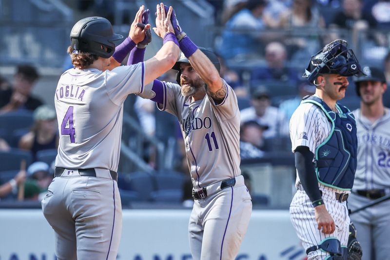 Aug 24, 2024; Bronx, New York, USA;  Colorado Rockies right fielder Jake Cave (11) is greeted by first baseman Michael Toglia (4) after hitting a two run home run in the seventh inning against the New York Yankees at Yankee Stadium. Mandatory Credit: Wendell Cruz-USA TODAY Sports