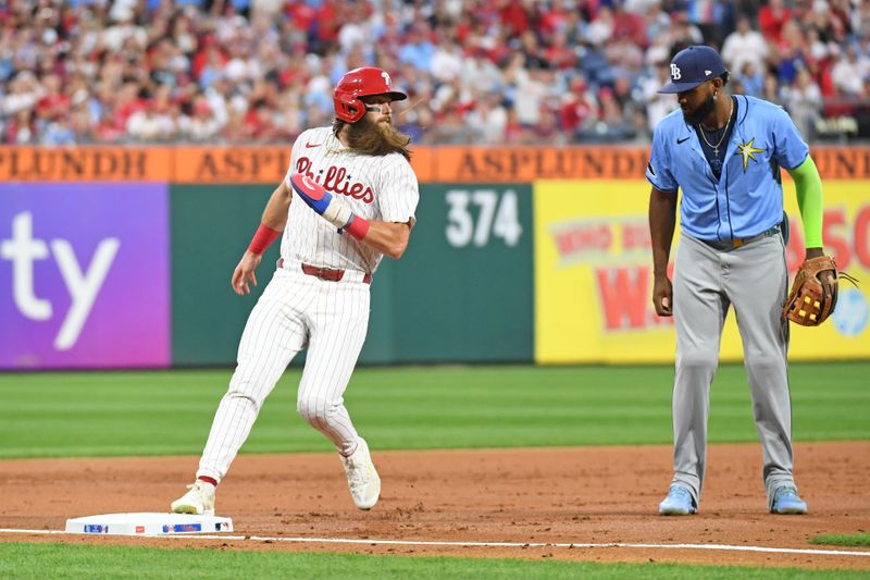 Sep 10, 2024; Philadelphia, Pennsylvania, USA; Philadelphia Phillies outfielder Brandon Marsh (16) stops briefly at third base before heading home to score a run on an overthrow during the second inning against the Tampa Bay Rays at Citizens Bank Park. Mandatory Credit: Eric Hartline-Imagn Images