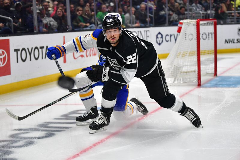 Feb 13, 2023; Los Angeles, California, USA; Los Angeles Kings left wing Kevin Fiala (22) plays for the puck against Buffalo Sabres defenseman Rasmus Dahlin (26) during the second period at Crypto.com Arena. Mandatory Credit: Gary A. Vasquez-USA TODAY Sports