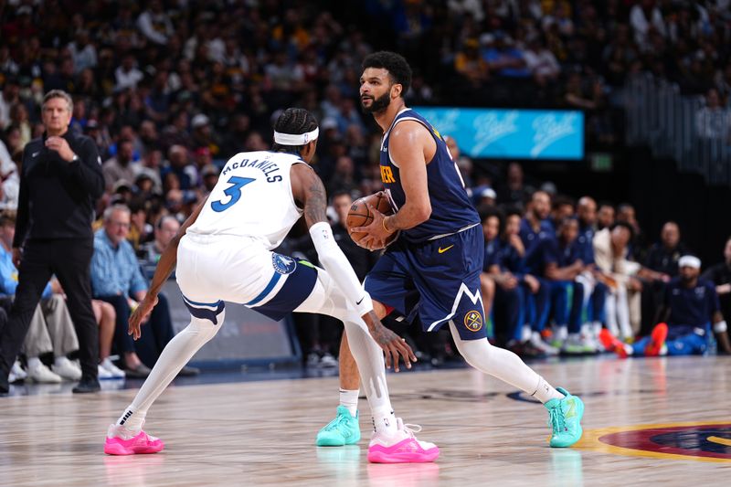 DENVER, CO - APRIL 10: Jamal Murray #27 of the Denver Nuggets looks to pass the ball during the game against the Minnesota Timberwolves on April 10, 2024 at the Ball Arena in Denver, Colorado. NOTE TO USER: User expressly acknowledges and agrees that, by downloading and/or using this Photograph, user is consenting to the terms and conditions of the Getty Images License Agreement. Mandatory Copyright Notice: Copyright 2024 NBAE (Photo by Garrett Ellwood/NBAE via Getty Images)