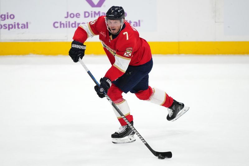 Nov 20, 2023; Sunrise, Florida, USA; Florida Panthers defenseman Dmitry Kulikov (7) passes the puck against the Edmonton Oilers during the first period at Amerant Bank Arena. Mandatory Credit: Jasen Vinlove-USA TODAY Sports