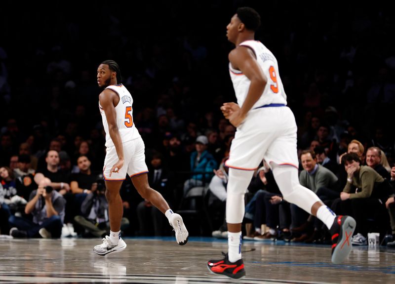 NEW YORK, NEW YORK - DECEMBER 20: Immanuel Quickley #5 of the New York Knicks reacts after scoring during the second half against the Brooklyn Nets at Barclays Center on December 20, 2023 in the Brooklyn borough of New York City. The Knicks won 121-102. NOTE TO USER: User expressly acknowledges and agrees that, by downloading and/or using this Photograph, user is consenting to the terms and conditions of the Getty Images License Agreement. (Photo by Sarah Stier/Getty Images)