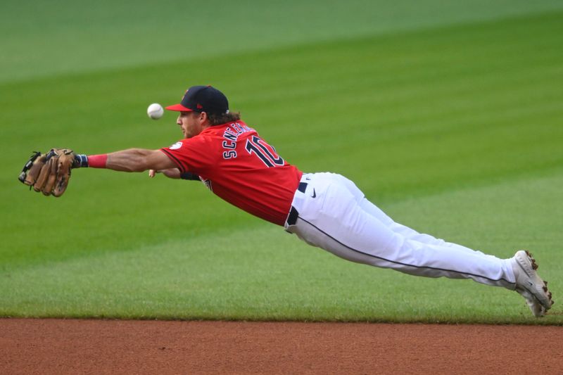 Jul 23, 2024; Cleveland, Ohio, USA; Cleveland Guardians shortstop Daniel Schneemann (10) dives for the ball on a base hit by the Detroit Tigers in the first inning at Progressive Field. Mandatory Credit: David Richard-USA TODAY Sports