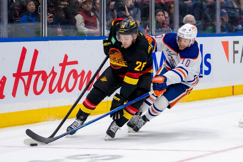 Nov 9, 2024; Vancouver, British Columbia, CAN; Edmonton Oilers forward Derek Ryan (10) stick checks Vancouver Canucks defenseman Erik Brannstrom (26) during the third period at Rogers Arena. Mandatory Credit: Bob Frid-Imagn Images