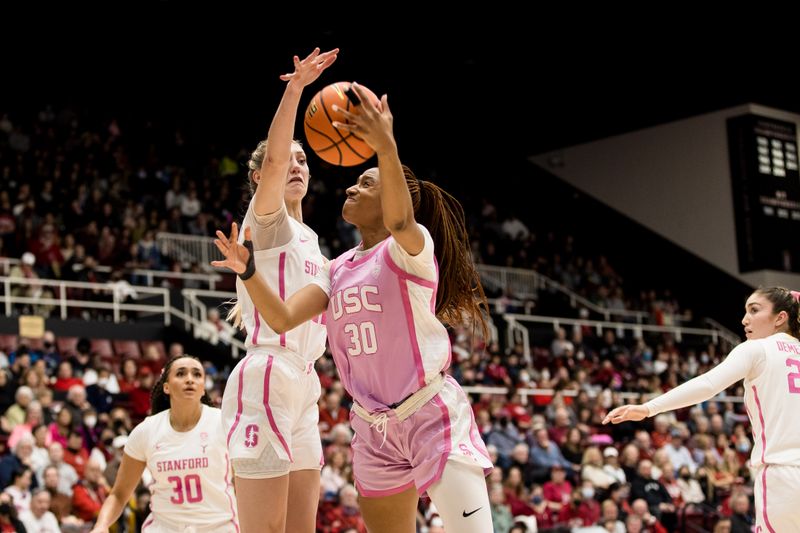 Feb 17, 2023; Stanford, California, USA;  Stanford Cardinal forward Cameron Brink (22) blocks a shot by USC Trojans forward Kadi Sissoko (30) during the first half at Maples Pavilion. Mandatory Credit: John Hefti-USA TODAY Sports