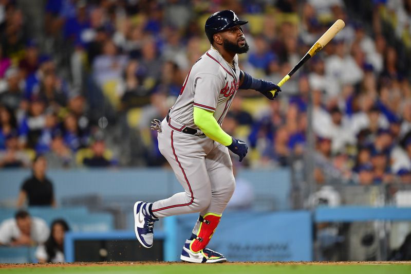 September 1, 2023; Los Angeles, California, USA; Atlanta Braves designated hitter Marcell Ozuna (20) hits an RBI single against the Los Angeles Dodgers during the fifth inning at Dodger Stadium. Mandatory Credit: Gary A. Vasquez-USA TODAY Sports