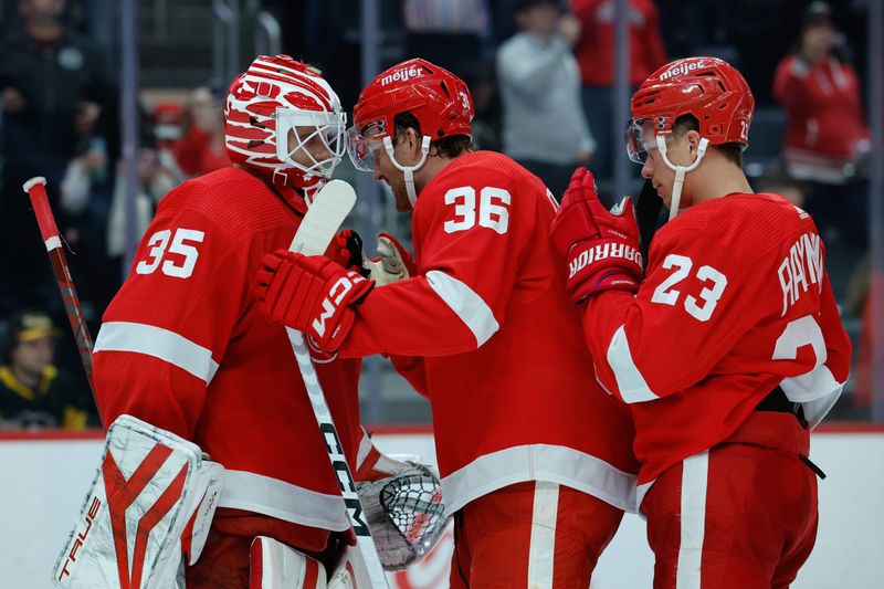 Oct 18, 2023; Detroit, Michigan, USA; Detroit Red Wings goaltender Ville Husso (35) right wing Christian Fischer (36) and left wing Lucas Raymond (23) celebrates after defeating the Pittsburgh Penguins at Little Caesars Arena. Mandatory Credit: Rick Osentoski-USA TODAY Sports