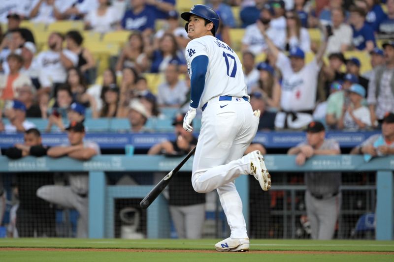 Jul 24, 2024; Los Angeles, California, USA;  Los Angeles Dodgers designated hitter Shohei Ohtani (17) hits a long fly ball for an out in the first inning against the San Francisco Giants at Dodger Stadium. Mandatory Credit: Jayne Kamin-Oncea-USA TODAY Sports