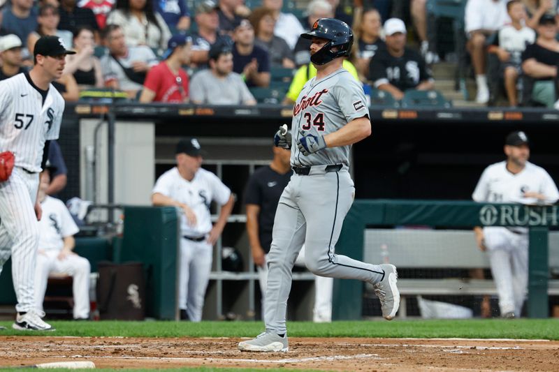 Aug 24, 2024; Chicago, Illinois, USA; Detroit Tigers catcher Jake Rogers (34) scores against the Chicago White Sox during the third inning at Guaranteed Rate Field. Mandatory Credit: Kamil Krzaczynski-USA TODAY Sports