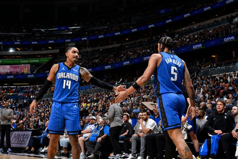 ORLANDO, FL - APRIL 1: Gary Harris #14 and Paolo Banchero #5 of the Orlando Magic react during the game against the Portland Trail Blazers on April 1, 2024 at Kia Center in Orlando, Florida. NOTE TO USER: User expressly acknowledges and agrees that, by downloading and or using this photograph, User is consenting to the terms and conditions of the Getty Images License Agreement. Mandatory Copyright Notice: Copyright 2024 NBAE (Photo by Fernando Medina/NBAE via Getty Images)