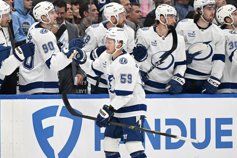 Mar 7, 2026; Toronto, Ontario, CAN;  Tampa Bay Lightning forward Jake Guentzel (59) celebrates with teammates at the bench after scoring a goal against the Toronto Maple Leafs in the first period at Scotiabank Arena. Mandatory Credit: Dan Hamilton-Imagn Images
