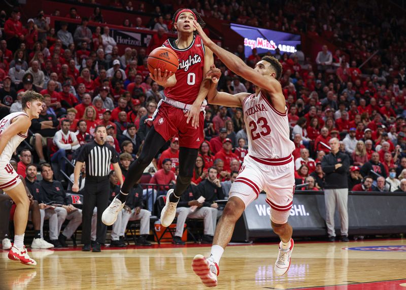 Dec 3, 2022; Piscataway, New Jersey, USA; Rutgers Scarlet Knights guard Derek Simpson (0) drives to the basket as Indiana Hoosiers forward Trayce Jackson-Davis (23) defends during the second half at Jersey Mike's Arena. Mandatory Credit: Vincent Carchietta-USA TODAY Sports