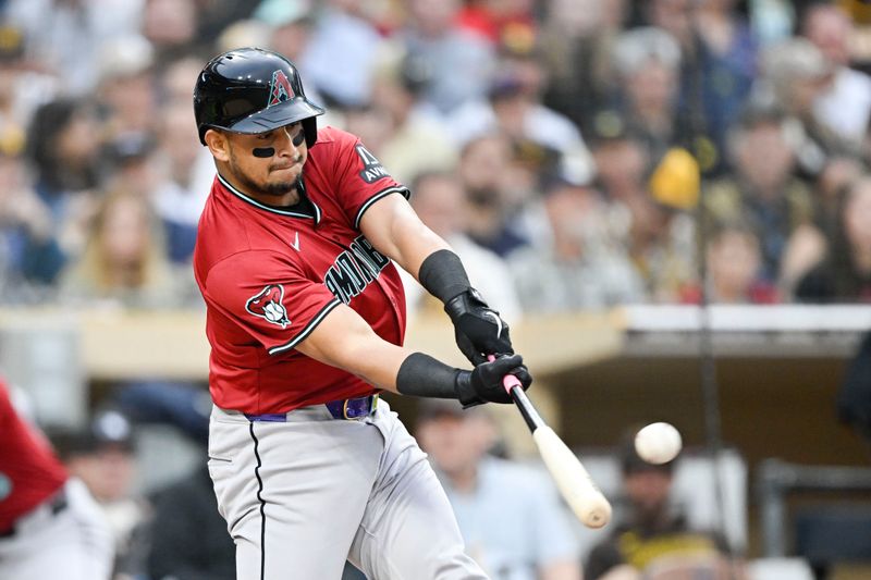 Jun 6, 2024; San Diego, California, USA; Arizona Diamondbacks catcher Gabriel Moreno (14) hits a solo home run during the second inning against the San Diego Padres at Petco Park. Mandatory Credit: Denis Poroy-USA TODAY Sports at Petco Park. 