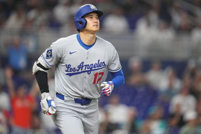 May 6, 2025; Miami, Florida, USA;  Los Angeles Dodgers designated hitter Shohei Ohtani (17) watches his solo home run go over the wall during the sixth inning against the Miami Marlins at loanDepot Park. Mandatory Credit: Jim Rassol-Imagn Images