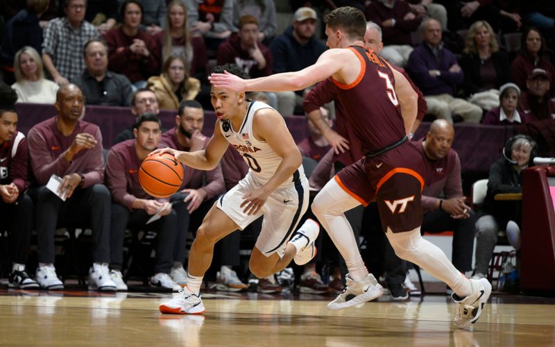 Feb 4, 2023; Blacksburg, Virginia, USA; Virginia Cavaliers guard Kihei Clark (0) dribbles around Virginia Tech Hokies guard Sean Pedulla (3) in the first half at Cassell Coliseum. Mandatory Credit: Lee Luther Jr.-USA TODAY Sports