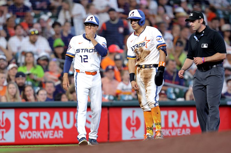 Apr 13, 2025; Houston, Texas, USA; Houston Astros second baseman Mauricio Dubón (14) talks with Houston Astros third base coach Tony Perezchica (12) while standing on third base against the Los Angeles Angels during the seventh inning at Daikin Park. Mandatory Credit: Erik Williams-Imagn Images
