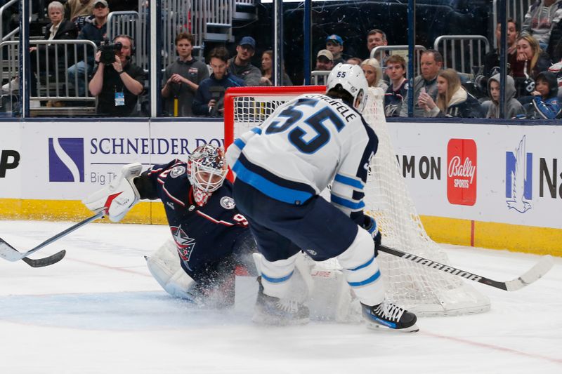 Mar 17, 2024; Columbus, Ohio, USA; Columbus Blue Jackets goalie Elvis Merzlikins (90) makes a save on the shot from Winnipeg Jets center Mark Scheifele (55) during the third period at Nationwide Arena. Mandatory Credit: Russell LaBounty-USA TODAY Sports