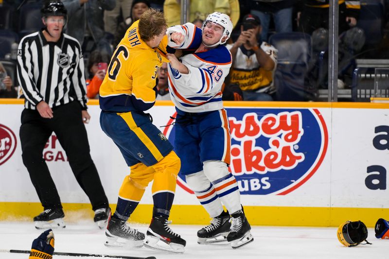 Oct 31, 2024; Nashville, Tennessee, USA;  Nashville Predators left wing Cole Smith (36) and Edmonton Oilers defenseman Ty Emberson (49) exchange blows uring the first period at Bridgestone Arena. Mandatory Credit: Steve Roberts-Imagn Images