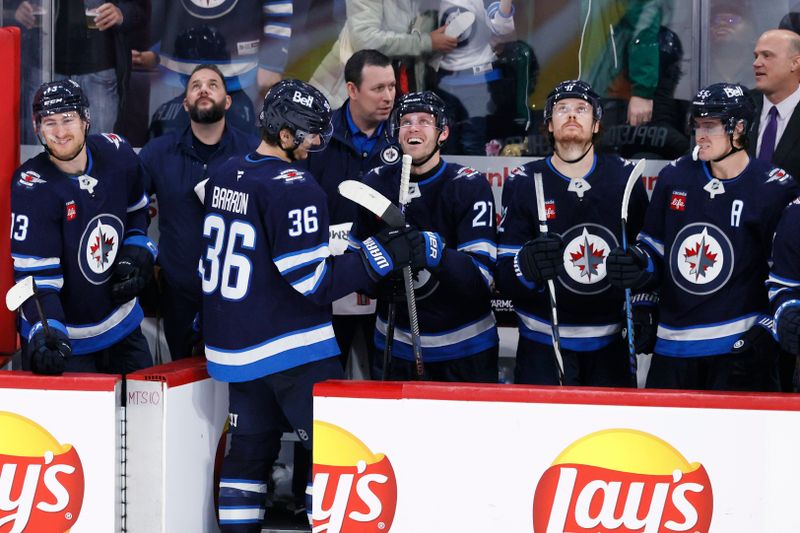 Nov 19, 2024; Winnipeg, Manitoba, CAN; Winnipeg Jets center Morgan Barron (36) celebrates his second empty net goal in the third period against the Florida Panthers at Canada Life Centre. Mandatory Credit: James Carey Lauder-Imagn Images