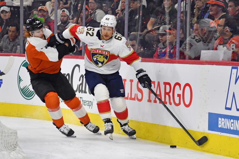 Mar 24, 2024; Philadelphia, Pennsylvania, USA; Florida Panthers defenseman Brandon Montour (62) holds off Philadelphia Flyers right wing Owen Tippett (74) during the first period at Wells Fargo Center. Mandatory Credit: Eric Hartline-USA TODAY Sports