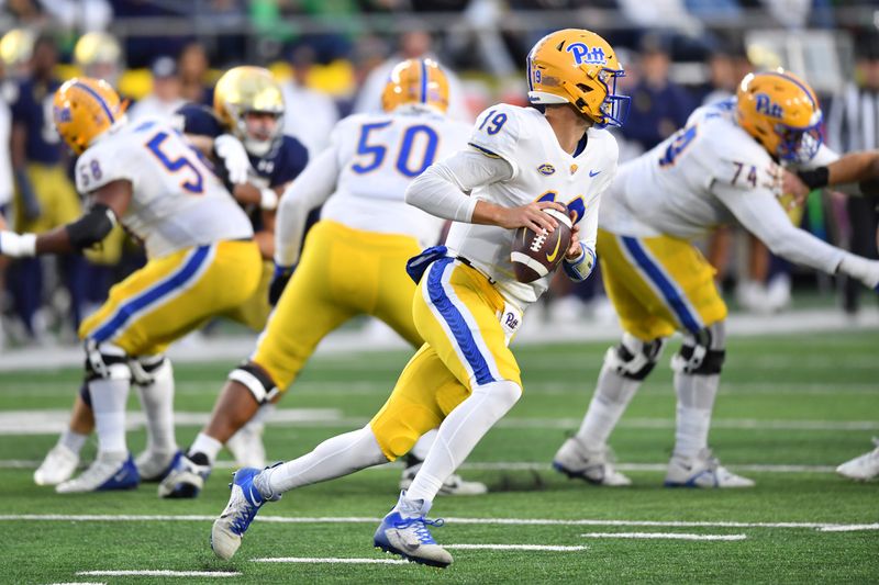 Oct 28, 2023; South Bend, Indiana, USA; Pittsburgh Panthers quarterback Nate Yarnell (19) rolls out to pass against the Notre Dame Fighting Irish in the fourth quarter at Notre Dame Stadium. Mandatory Credit: Matt Cashore-USA TODAY Sports