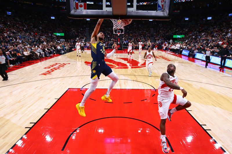 TORONTO, CANADA - NOVEMBER 18: Tyrese Haliburton #0 of the Indiana Pacers dunks the ball during the game against the Toronto Raptors on November 18, 2024 at the Scotiabank Arena in Toronto, Ontario, Canada.  NOTE TO USER: User expressly acknowledges and agrees that, by downloading and or using this Photograph, user is consenting to the terms and conditions of the Getty Images License Agreement.  Mandatory Copyright Notice: Copyright 2024 NBAE (Photo by Vaughn Ridley/NBAE via Getty Images)