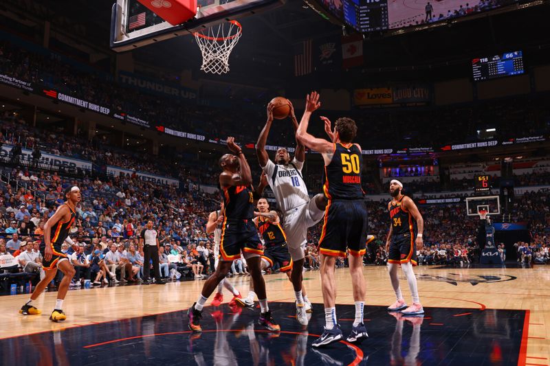 OKLAHOMA CITY, OK - APRIL 14:  Olivier Maxence-Prosper #18 of the Dallas Mavericks drives to the basket during the game against the Oklahoma City Thunder on April 14, 2024 at Paycom Arena in Oklahoma City, Oklahoma. NOTE TO USER: User expressly acknowledges and agrees that, by downloading and or using this photograph, User is consenting to the terms and conditions of the Getty Images License Agreement. Mandatory Copyright Notice: Copyright 2024 NBAE (Photo by Zach Beeker/NBAE via Getty Images)