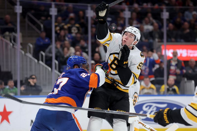 Nov 4, 2025; Elmont, New York, USA; New York Islanders left wing Anders Lee (27) cross checks Boston Bruins center Fraser Minten (93) during the second period at UBS Arena. A penalty was called on Lee for the hit. Mandatory Credit: Brad Penner-Imagn Images