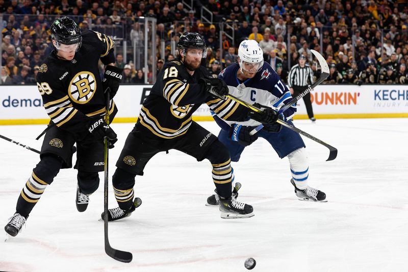 Jan 22, 2024; Boston, Massachusetts, USA; Boston Bruins center Pavel Zacha (18) holds off Winnipeg Jets center Adam Lowry (17) as center Morgan Geekie (39) goes for the puck during the second period at TD Garden. Mandatory Credit: Winslow Townson-USA TODAY Sports