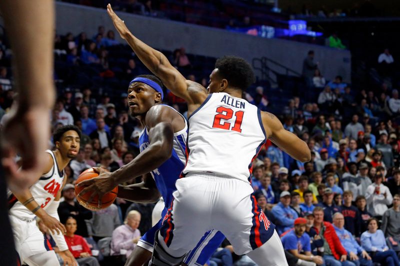 Jan 31, 2023; Oxford, Mississippi, USA; Kentucky Wildcats forward Oscar Tshiebwe (34) spins toward the basket as Mississippi Rebels forward Robert Allen (21) defends during the first half at The Sandy and John Black Pavilion at Ole Miss. Mandatory Credit: Petre Thomas-USA TODAY Sports