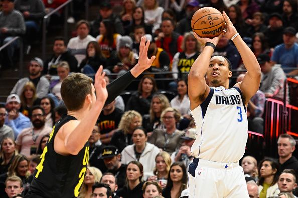 SALT LAKE CITY, UTAH - JANUARY 01: Grant Williams #3 of the Dallas Mavericks shoots over Walker Kessler #24 of the Utah Jazz during the second half of a game at Delta Center on January 01, 2024 in Salt Lake City, Utah. NOTE TO USER: User expressly acknowledges and agrees that, by downloading and or using this photograph, User is consenting to the terms and conditions of the Getty Images License Agreement. (Photo by Alex Goodlett/Getty Images)