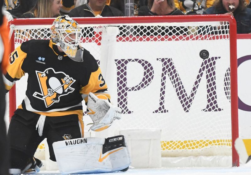 Nov 25, 2023; Pittsburgh, Pennsylvania, USA; The puck flies past Pittsburgh Penguinsgoalie Tristan Jarry (35) against the Toronto Maple Leafs during the third period at PPG Paints Arena. Mandatory Credit: Philip G. Pavely-USA TODAY Sports