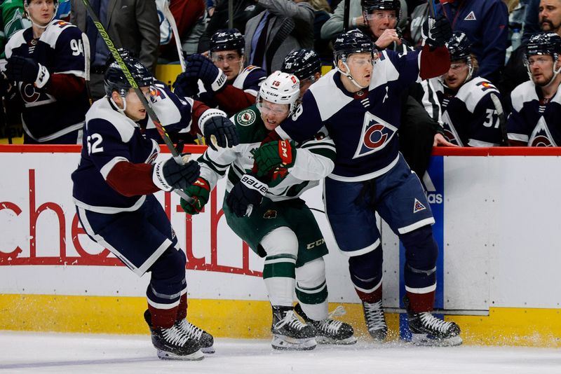 Mar 8, 2024; Denver, Colorado, USA; Colorado Avalanche center Nathan MacKinnon (29) is held up by Minnesota Wild center Mason Shaw (15) as left wing Artturi Lehkonen (62) defends 2 at Ball Arena. Mandatory Credit: Isaiah J. Downing-USA TODAY Sports