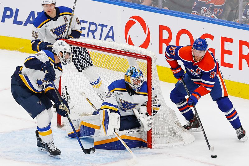 Feb 28, 2024; Edmonton, Alberta, CAN; Edmonton Oilers forward Connor McDavid (97) makes a pass from behind St. Louis Blues goaltender Jordan Binnington (50) during the third period at Rogers Place. Mandatory Credit: Perry Nelson-USA TODAY Sports