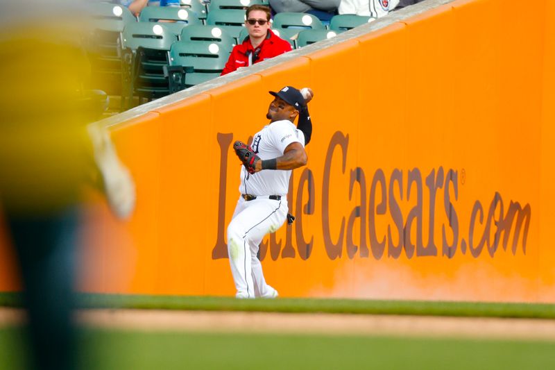 Apr 7, 2024; Detroit, Michigan, USA; Detroit Tigers third base Andy Ibáñez (77) throws the ball to the infield during the game against the Oakland Athletics at Comerica Park. Mandatory Credit: Brian Bradshaw Sevald-USA TODAY Sports